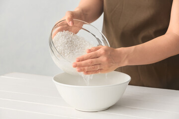 Woman preparing rice water on table