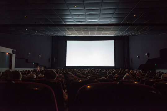Empty cinema screen with audience. Ready for adding your picture.