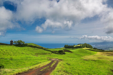 road through green hills landscape on Sao Miguel island, Portugal