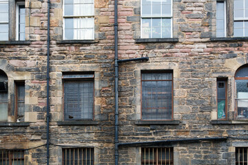 A tenement is a multi-occupancy building of any sort. The term usually refers to a run-down apartment building or slum - Edinburgh,  Scotland.