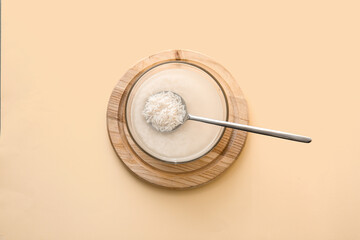 Bowl of rice water on color background
