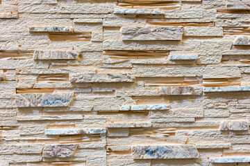 Stacked stone wall, natural stone cladding. Stone wall for background,Slab stone wall texture. Wall background of volcanic andesite basalt stone texture