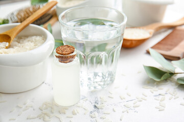Bottle of rice water on white background