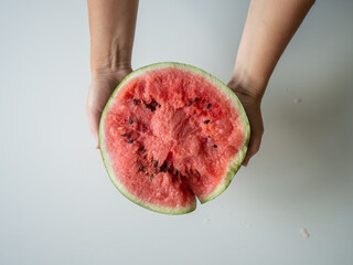 Juicy ripe watermelon in half on a white table