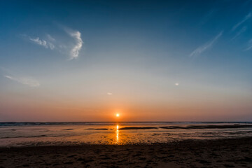 Fototapeta na wymiar Sunset on beach of Atlantic Ocean