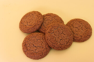 close up of five round oatmeal biscuits on yellow background