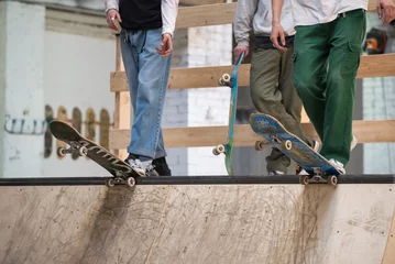 Gordijnen Skateboarder ready to roll, feet on skateboard © smspsy