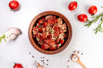 Obraz na płótnie Canvas Bowl of sun dried tomatoes garlic, oregano, olive oil, top view
