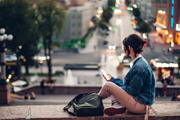 Girl with phone in street lights