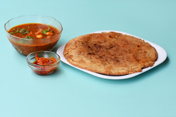 Indian flatbread - Aloo Kulcha with Choley or Stuffed Potato Bread or Stuffed Aloo paratha with tomato ketchup, white chickpeas & pickle - Image