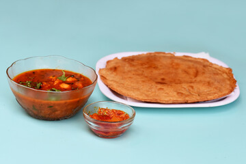 Indian flatbread - Aloo Kulcha with Choley or Stuffed Potato Bread or Stuffed Aloo paratha with tomato ketchup, white chickpeas & pickle - Image