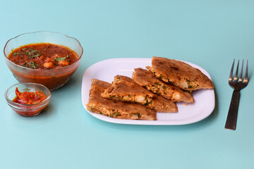 Indian flatbread - Aloo Kulcha with Choley or Stuffed Potato Bread or Stuffed Aloo paratha with tomato ketchup, white chickpeas & pickle - Image