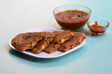 Indian flatbread - Aloo Kulcha with Choley or Stuffed Potato Bread or Stuffed Aloo paratha with tomato ketchup, white chickpeas & pickle - Image