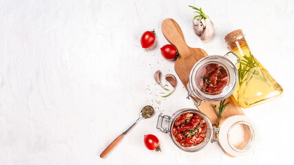 Fototapeta na wymiar Sun dried tomatoes with fresh herbs and spices. Delicious snack on wooden textured background, top view. space for text. Long banner format