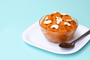 Indian traditional sweet,Plain SemolinaSuji Halwa also known as Sweet Rava Sheera OR Shira - Indian festival sweet garnished with dry fruitsServed in a plate or Bowl,Indian dessert