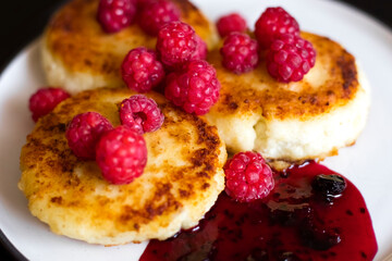 Delicious cottage cheese pancakes with fresh raspberries and jam. Healthy, summer Breakfast