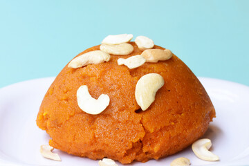Indian traditional sweet,Plain SemolinaSuji Halwa also known as Sweet Rava Sheera OR Shira - Indian festival sweet garnished with dry fruitsServed in a plate or Bowl,Indian dessert