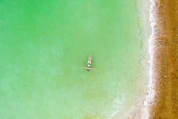 woman bathes in twoman bathes in the dead sea. Aerial view he dead sea. Aerial view. High quality photo