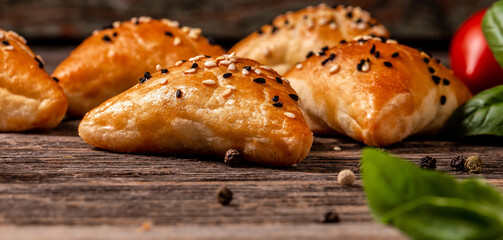 Samosas, oriental uzbek cuisine, Central Asian cuisine. samsa with chicken and sprinkled with sesame seeds, samosa on a wooden board, Long banner format. space for text
