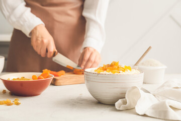 Obraz na płótnie Canvas Woman preparing tasty rice in kitchen, closeup
