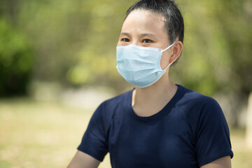 Asian woman wearing face mask  in city