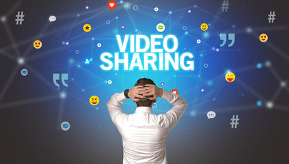 Rear view of a businessman with VIDEO SHARING inscription, social networking concept