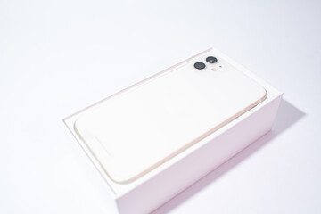 White smartphone with two cameras on a white background