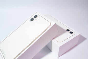 White smartphone with two cameras on a white background