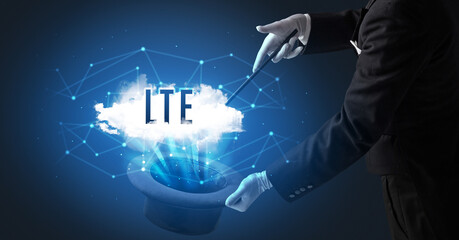 Magician is showing magic trick with LTE abbreviation, modern tech concept