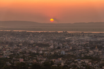 Sunset over Irrawaddy river and Mandalay city, Myanmar. Mandalay is the second-largest city in Myanmar, after Yangon, and is located on the east bank of the Irrawaddy River