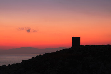 Obraz premium Dawn breaking behind genoese tower in Corsica