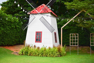 Red  window in white house.