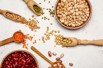 Different raw legumes on white background