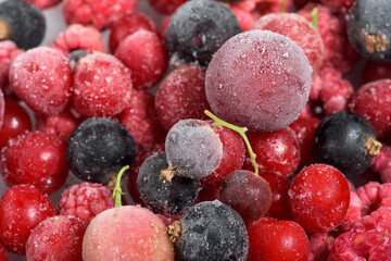frozen fruit cherry, raspberry, blackcurrant in bags, close-up view from above