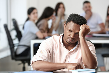 Lonely African-American man in office. Stop racism
