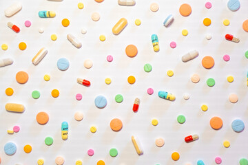 Colorful drugs, vitamins and medicine - capsules, tablets, pills - against white background