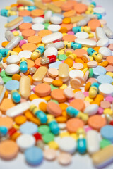 Fototapeta na wymiar Colorful drugs, vitamins and medicine - capsules, tablets, pills - against white background