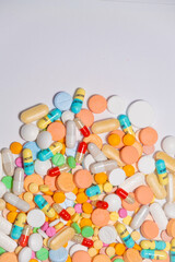 Colorful drugs, vitamins and medicine - capsules, tablets, pills - against white background