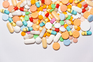 Colorful drugs, vitamins and medicine - capsules, tablets, pills - against white background