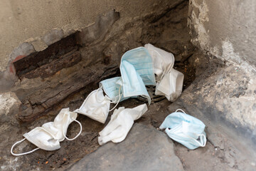 used surgical mask on the floor. discarded mask concept corona virus,covid-19.