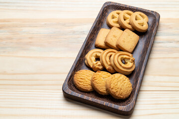 Cookies in a wooden plate on wooden table