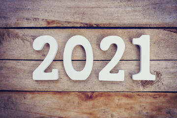 New year 2021 concept - wooden number 2021 for Happy new year text on wood table.