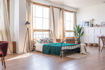 Vintage studio apartment interior in light colors in old style. huge room with large windows with a...