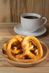 pretzels on wood table and black coffee