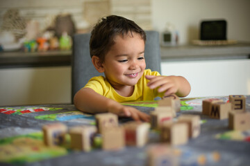 young child playing with cubes