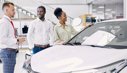 beautiful black afro couple attentively listen to consultant in dealership, confident salesman...