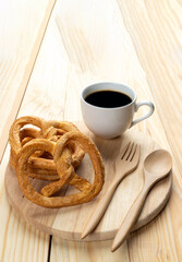 pretzels on wood table and black coffee