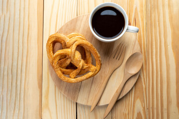 pretzels on wood table and black coffee