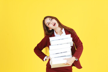 Businesswoman in red suit hand holding document books isolated on yellow background. Copy Space