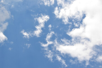 Clouds background. Blue sky with fluffy white clouds. Sunny day with beautiful weather.